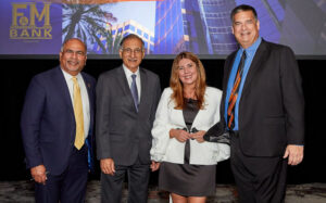 Sridhar Sundaram, Anil Puri, Mira Farka and Jeff Ball pose for a group photo at the 32nd Annual Economic Forecast Conference.