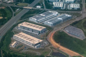 An aerial view of a dense cluster of data centers, including facilities under construction, in Loudoun County's Data Center Alley in Northern Virginia.