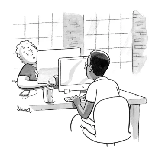 Two men working at desktop computers.
