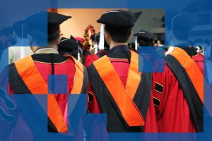 Three East Asian PhD graduates seen from behind, wearing graduation gowns and hats at their graduation ceremony.